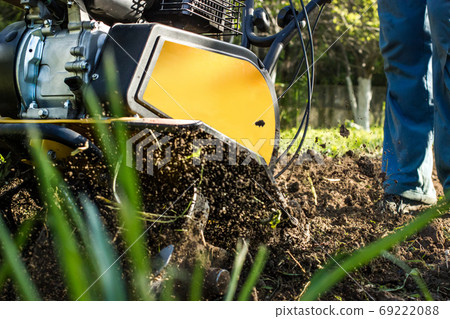 Grass and plowed soil nuggets during motor cultivator farm spring work Grass and plowed soil nuggets during motor cultivator farm spring work 69222088