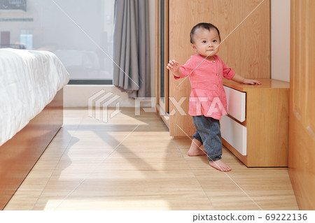 Little girl exploring apartment Little girl exploring apartment 69222136