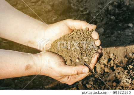 A close up view on soil in mans palms A close up view on soil in mans palms 69222150