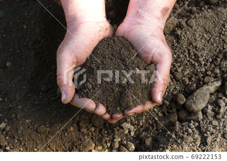 A close up view on moistured soil in mans hands A close up view on moistured soil in mans hands 69222153