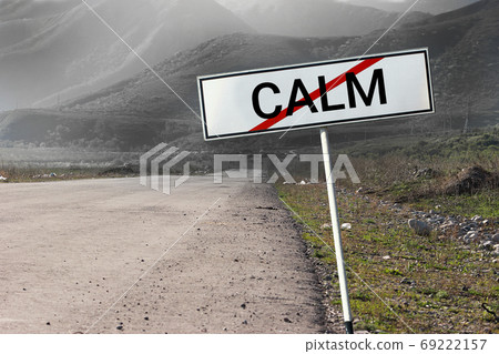 Road and road sign crossed out word Calm. Uneasy emotion negative feeling concept background sign Road and road sign crossed out word Calm. Uneasy emotion negative feeling concept background sign 69222157