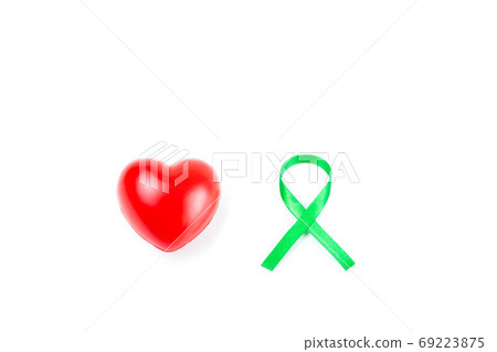green organ transplant awareness ribbon and red heart on white background.Kidneys cancer .healthcare and medicine concept green organ transplant awareness ribbon and red heart on white background.Kidneys cancer .healthcare and medicine concept 69223875