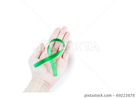 Hand holding green organ transplant awareness ribbon.Kidneys cancer .healthcare and medicine concept Hand holding green organ transplant awareness ribbon.Kidneys cancer .healthcare and medicine concept 69223878