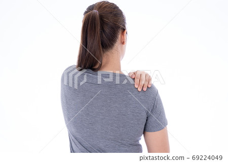 A woman feeling exhausted and suffering from shoulder and neck pain and injury on isolated white A woman feeling exhausted and suffering from shoulder and neck pain and injury on isolated white 69224049