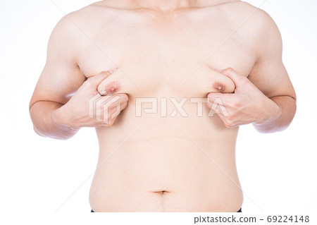 Close up man holding men boobs on white background. Close up man holding men boobs on white background. 69224148