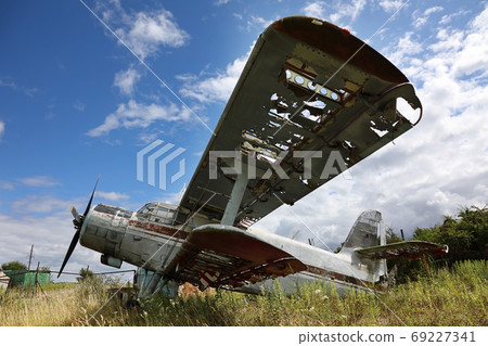 Old crashed and abandoned small propeller plane. Airplane gravey Old crashed and abandoned small propeller plane. Airplane gravey 69227341