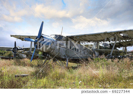 Abandoned old small propeller plane. Airplane graveyard 69227344