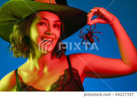 Young woman in black witch costume Young woman in black witch costume 69227397