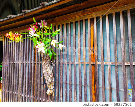 Flowers nestling on the old street corner 69227561
