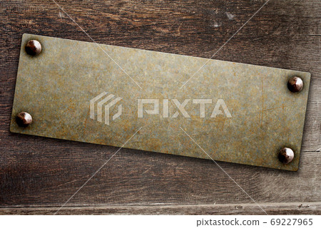 Grunge background with metallic plate on wood board 69227965