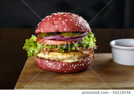red burger on a cutting board 69228546