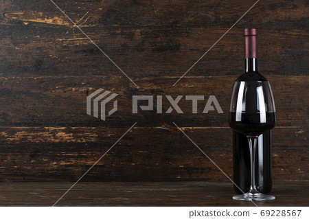 Bottle with red wine and glass 69228567