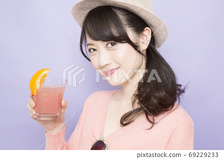 Woman drinking tropical juice 69229233