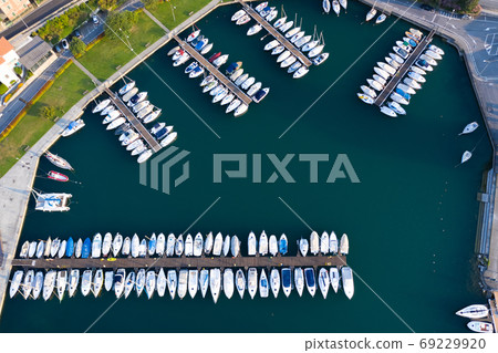 Boats moored at dock Boats moored at dock 69229920