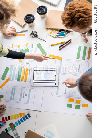Top view of several creative professional developers discussing sketches 69230299