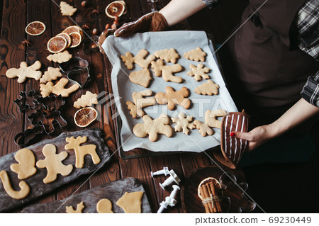 Woman with baked homemade gingerbread cookies Woman with baked homemade gingerbread cookies 69230449