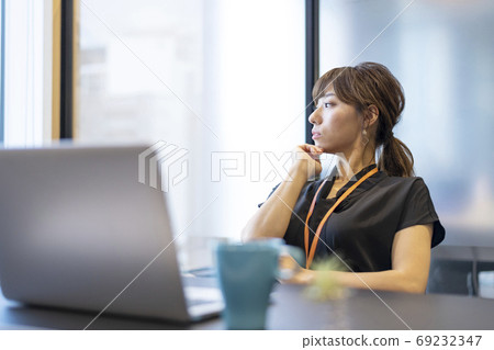 Woman resting tired from computer work looking at distant view Woman resting tired from computer work looking at distant view 69232347