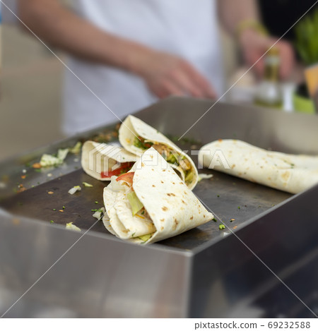 Fast food cooking. Portion of tortilla, fajitas, process of preparing. Concept of national food, healthy fast food 69232588
