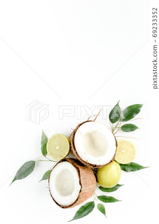 Creative pattern made of summer tropical fruits: coconut, lime and leaves ficus. Food concept. flat lay, top view Creative pattern made of summer tropical fruits: coconut, lime and leaves ficus. Food concept. flat lay, top view 69233352