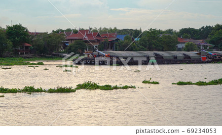 A cargo ship passing through on Chao Phraya River or sea with co A cargo ship passing through on Chao Phraya River or sea with co 69234053