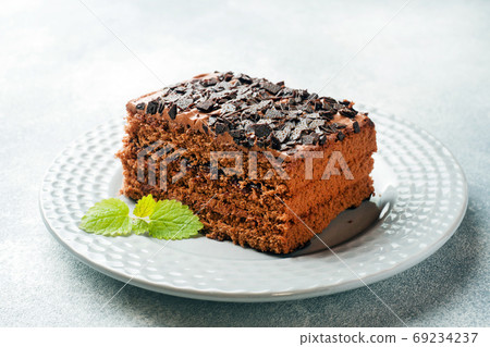 A piece of truffle cake with chocolate on a gray concrete background. Copy space A piece of truffle cake with chocolate on a gray concrete background. Copy space 69234237