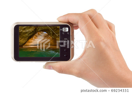 Hand with camera and Beach in Lagos - Algarve Portugal - Portuga Hand with camera and Beach in Lagos - Algarve Portugal - Portuga 69234331