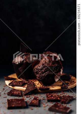 chocolate cupcakes close up on a dark background with bitter chocolate 69234371