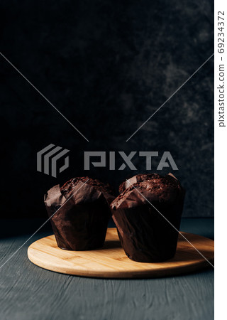 chocolate cupcakes close up on a dark background chocolate cupcakes close up on a dark background 69234372