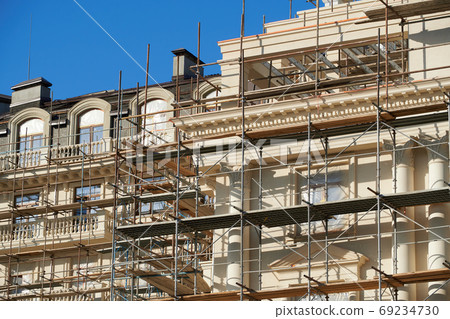 scaffolding and new building as background scaffolding and new building as background 69234730