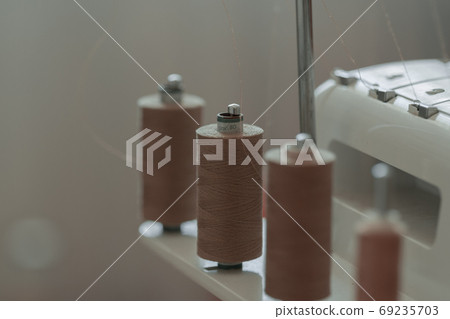 Light brown sewing thread in a row 69235703