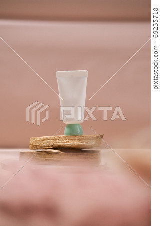 Cosmetic tube on neutral pastel nude background 69235718