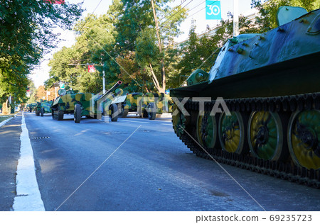 military parade in the city, ordered military equipment, tanks, guns and other weapons in the street for celebration military parade in the city, ordered military equipment, tanks, guns and other weapons in the street for celebration 69235723