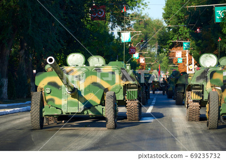 military parade in the city, ordered military equipment, tanks, guns and other weapons in the street for celebration military parade in the city, ordered military equipment, tanks, guns and other weapons in the street for celebration 69235732