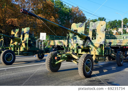 military parade in the city, ordered military equipment, tanks, guns and other weapons in the street for celebration military parade in the city, ordered military equipment, tanks, guns and other weapons in the street for celebration 69235734