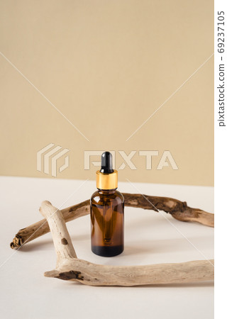 Bottle of cosmetics on a natural beige background. Bottle of cosmetics on a natural beige background. 69237105