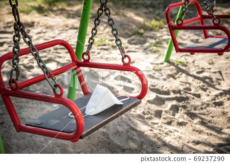 Mask placed on the swing. concept of coronavirus epidemic Mask placed on the swing. concept of coronavirus epidemic 69237290