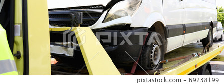 Wrecked car stands on tow truck closeup. 69238199