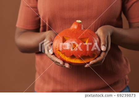 Unrecognizable Woman Holding Pumpkin Unrecognizable Woman Holding Pumpkin 69239873