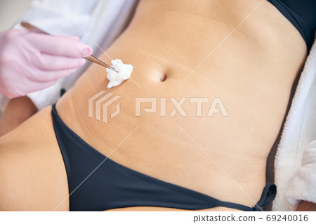 Doctor preparing a woman for a medical procedure Doctor preparing a woman for a medical procedure 69240016