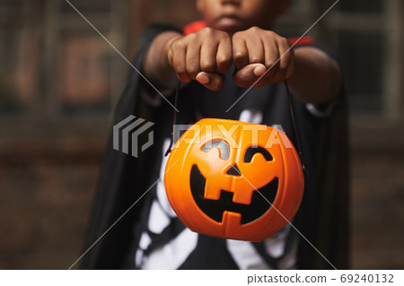 Boy Demonstrating Basket For Candies Boy Demonstrating Basket For Candies 69240132