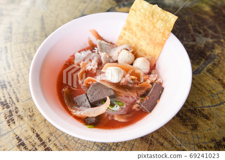 Noodles with seafood on red soup - hot and spicy thai food noodl 69241023