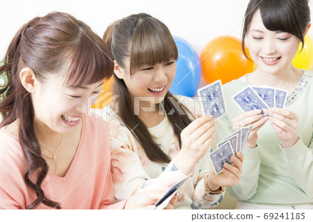 Woman enjoying a card game 69241185