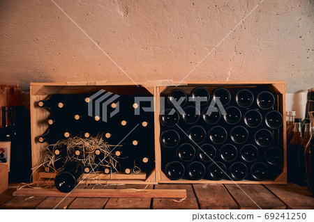 Wine cellar with wine bottles in wooden crates 69241250