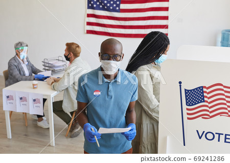 People Wearing PPE at Voting Station People Wearing PPE at Voting Station 69241286