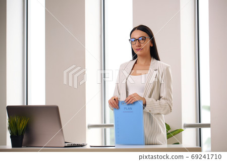 Portrait of young successful businesswoman in the office. Portrait of young successful businesswoman in the office. 69241710