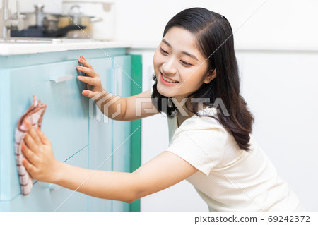 Woman housecleaning Woman housecleaning 69242372