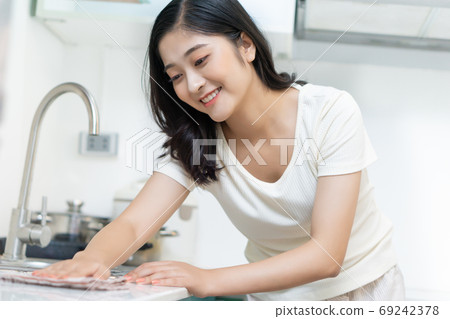 Woman housecleaning Woman housecleaning 69242378