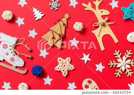 Top view of holiday toys and decorations on red Christmas background. New Year time concept 69242554