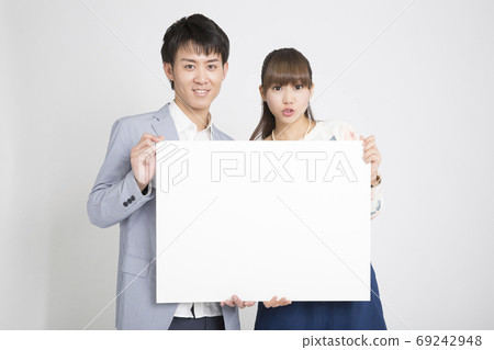 Male and female with message board Male and female with message board 69242948