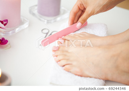 Young woman getting professional pedicure at home Young woman getting professional pedicure at home 69244346